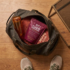 Nura CoQ10 Ubiquinone pouch packed in a gym bag with a water bottle and towel