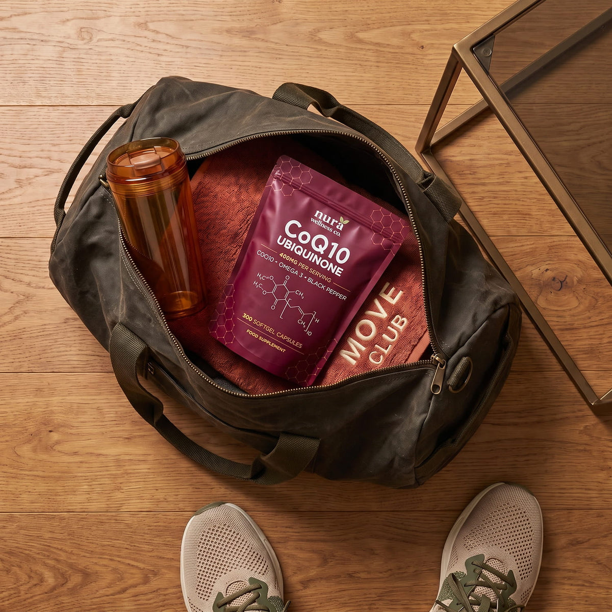 Nura CoQ10 Ubiquinone pouch packed in a gym bag with a water bottle and towel