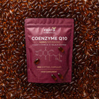 Nura Coenzyme Q10 pouch, 400mg per serving and 300 softgel capsules, lying on a bed of amber softgels