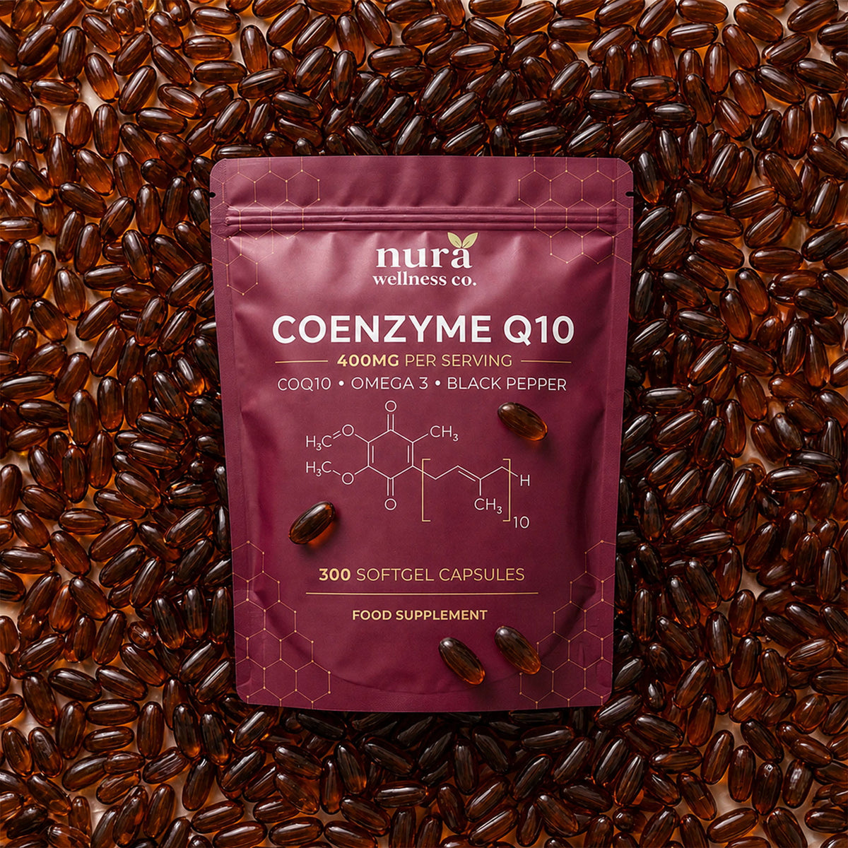Nura Coenzyme Q10 pouch, 400mg per serving and 300 softgel capsules, lying on a bed of amber softgels
