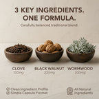 Nura Wormwood, Black Walnut & Clove pouch on a wooden table with walnuts and capsules, shown with vegan, non-GMO, gluten-free, third-party lab tested and formulated in the UK badges