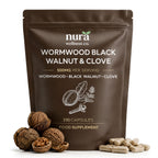 Clear vegan capsule filled with ground sweet wormwood, black walnut and clove, surrounded by whole cloves and walnuts